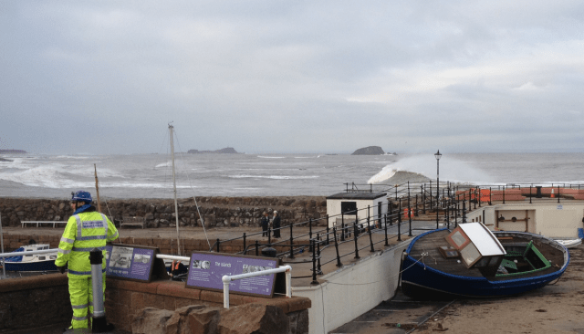 Girl Pat Against Cubicle Block Damaged Harbour Wall Between Breaking Wave and Pump House