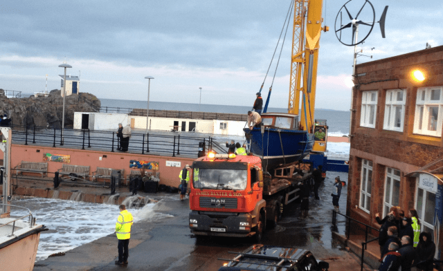 Girl Pat Is Strapped Down for Removal—Note Water from Afternoon Tide on Esplanade & Flowing into Harbour