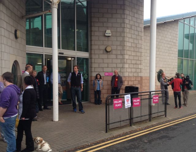 Three Pipers play. NO on the left of the door YES on the right